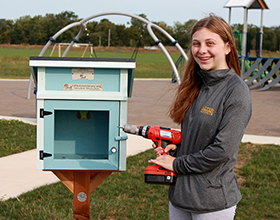 Lauren Shenk installs Little Free Library at Robert F. Mays Park