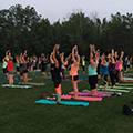 People participating in evening yoga outside