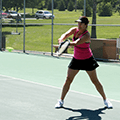 woman hitting a tennis ball with a raquet