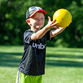 young boy caching a yellow ball