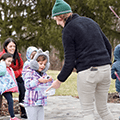 preschooler and program leader examining nature object