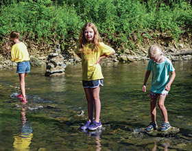 Three Hidden Meadows Day Camoers playing in Holes Creek