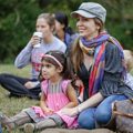 Mother and daughter sitting on grass