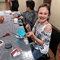 girl painting recycled cardboard craft