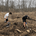 two boys digging a vernal pool