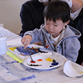 little boy painting a canvas