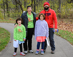 Family in Great Turkey Trek t-shirts standing on paved path