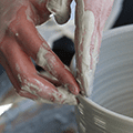 hands shaping clay