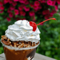 ice cream sundae with whipped cream and a cherry