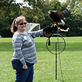 a woman holding a falcon