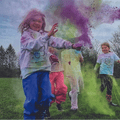 children getting sprayed with colorful dust