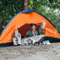 children sitting in an orange tent