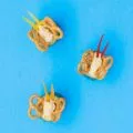 Edible butterfly craft made from cucumbers, hummus, pretzels, and peppers