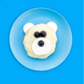bagel made to look like a polar bear on a blue plate