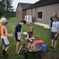 5 children roasting marshmallows over a campfire